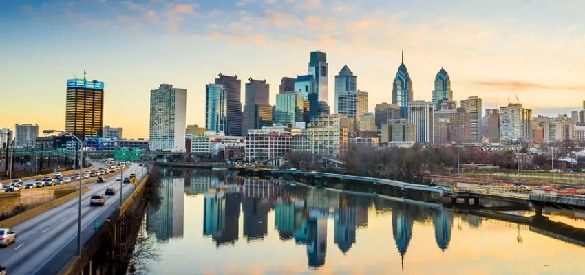 Philadelphia skyline at sunrise reflected in a river