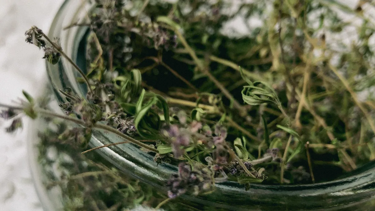 Glass jar of dried thyme sprigs