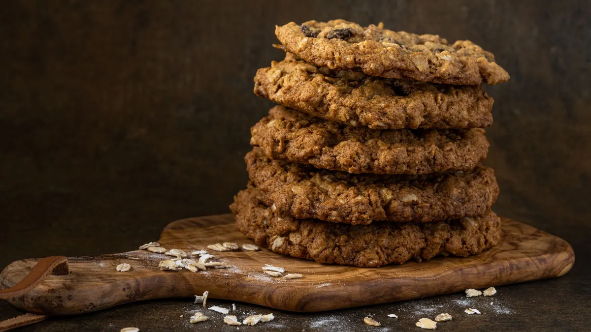 A stack of oatmeal cookies on a wooden board
