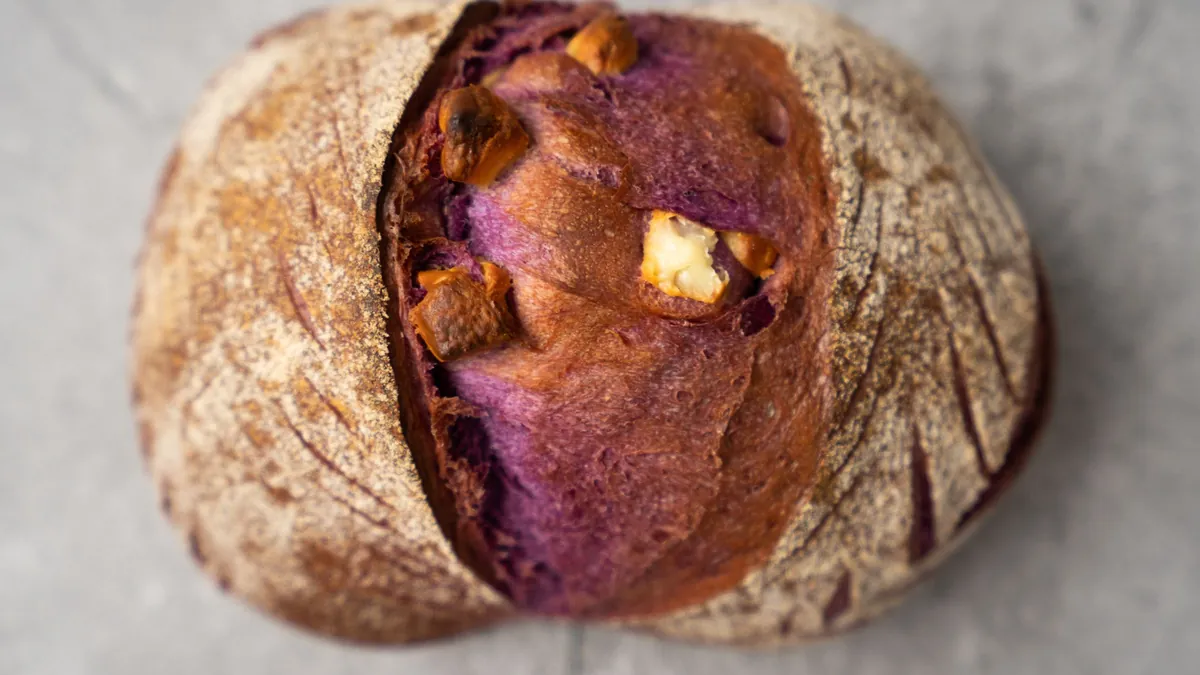 Round loaf of bread cut open to show a purple filling