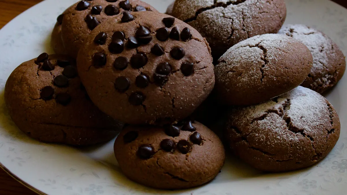 Plate of chocolate chip cookies dusted with powdered sugar