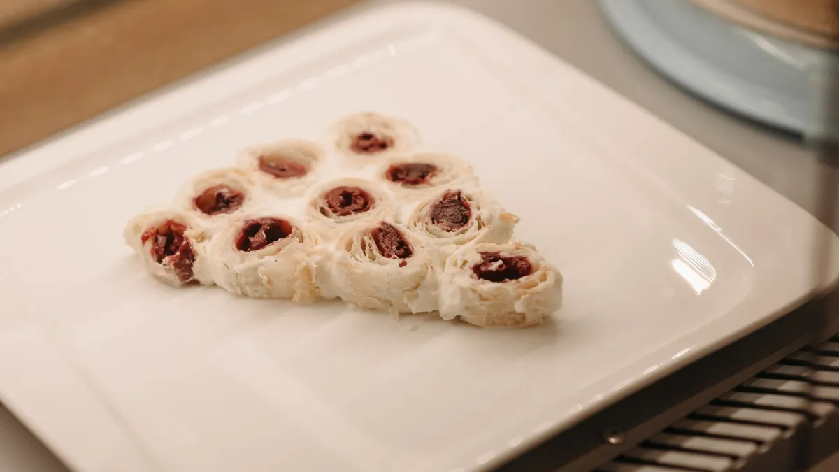 Rolled cherry pastry arranged on a white plate