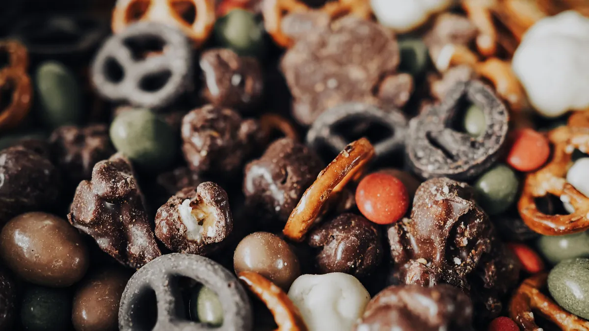 Close-up of chocolate-covered pretzels, nuts and candies