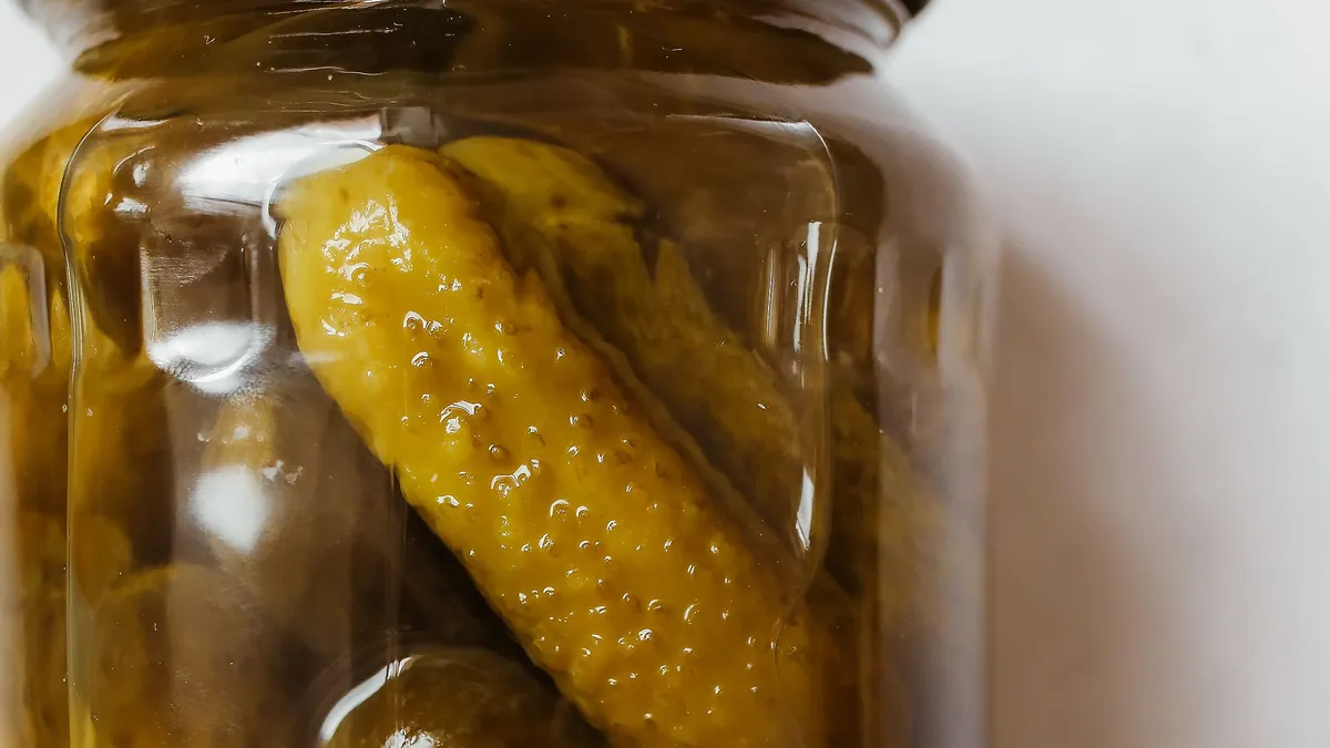 Glass jar of pickled cucumbers