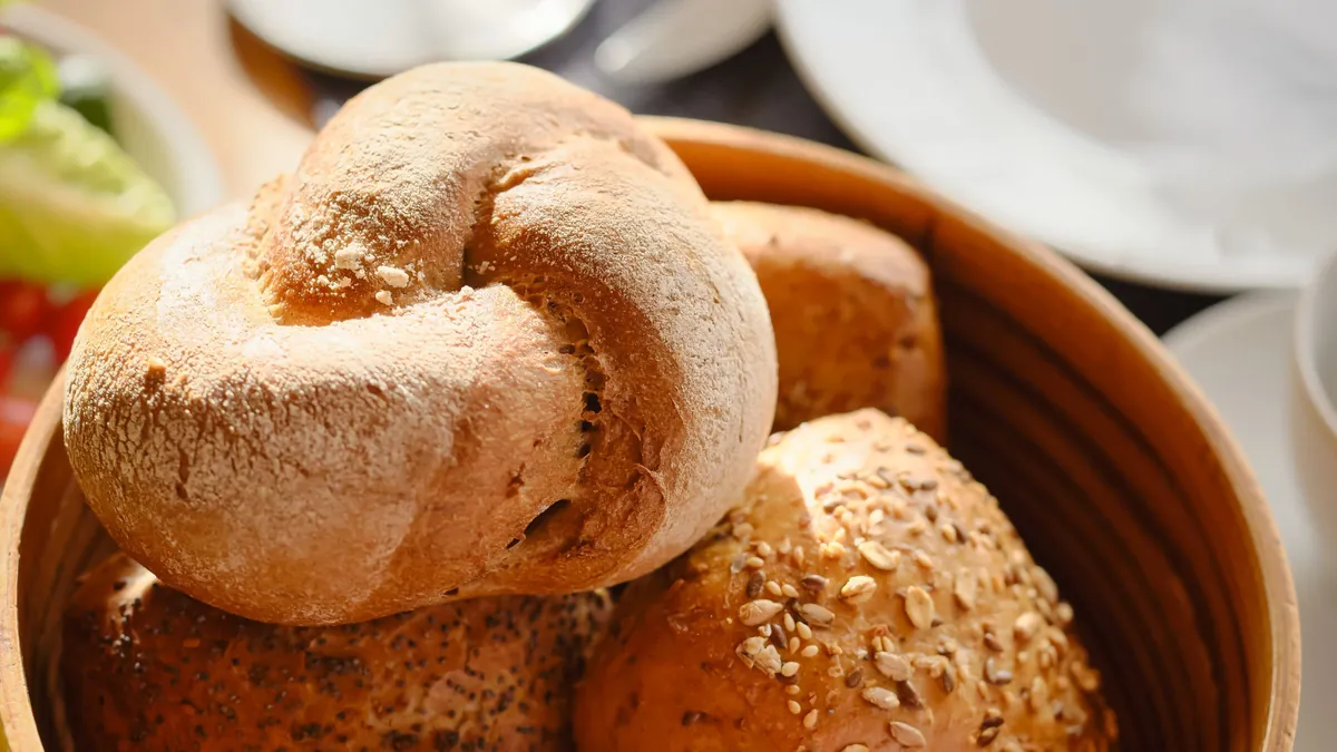 Wicker bowl of fresh bread rolls with seeds