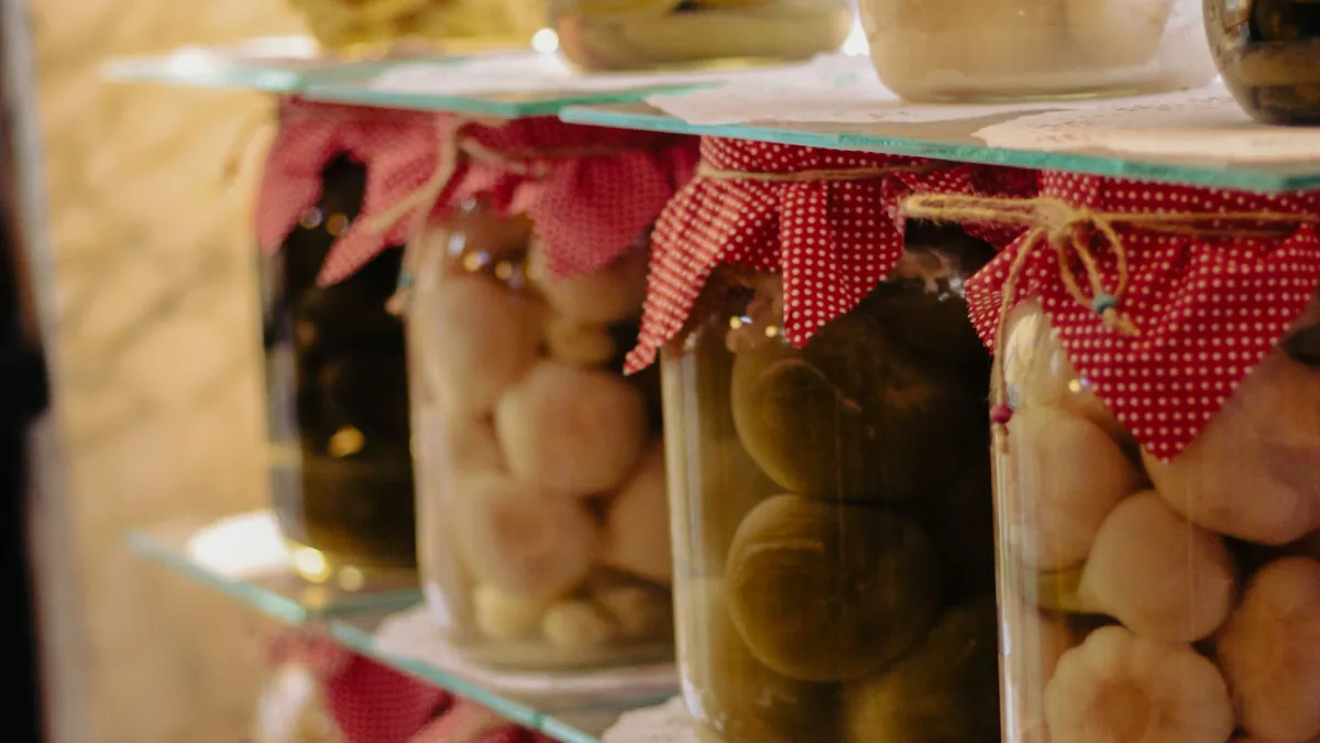 Glass jars of preserved vegetables with red gingham lids on a shelf