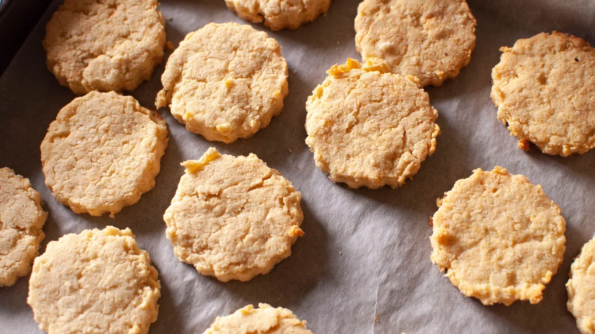 Homemade biscuits on a parchment-lined baking tray