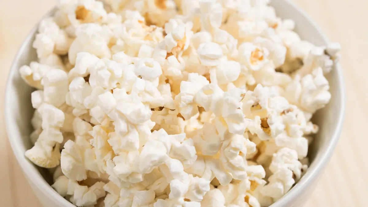 White ceramic bowl of freshly popped popcorn