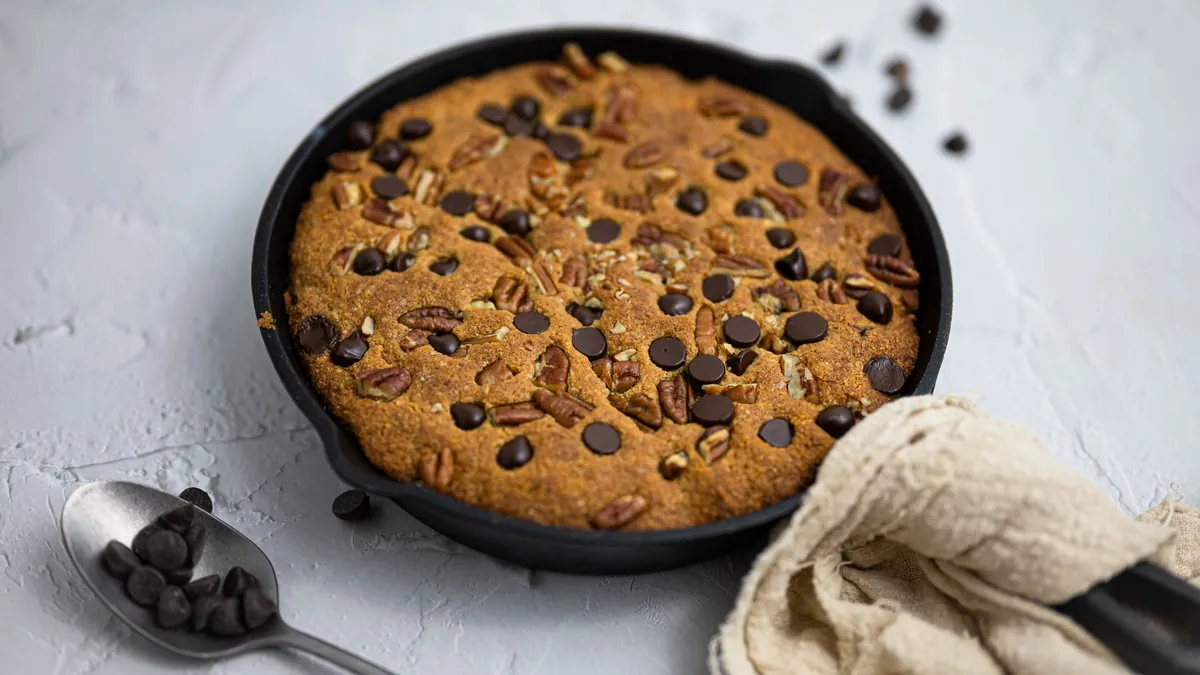 Skillet cookie with pecans and chocolate chips in a cast iron pan