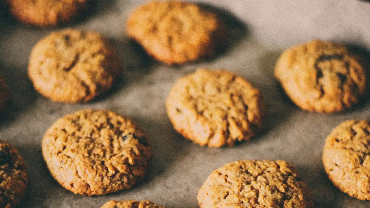 Freshly baked oatmeal cookies on a parchment-lined baking tray