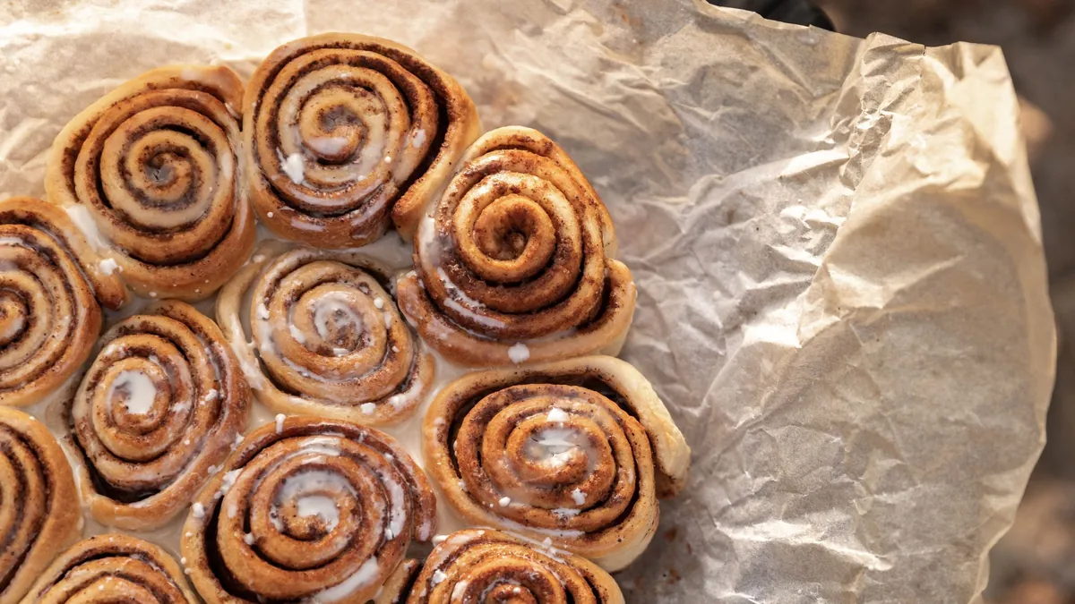 Freshly baked cinnamon rolls on parchment paper