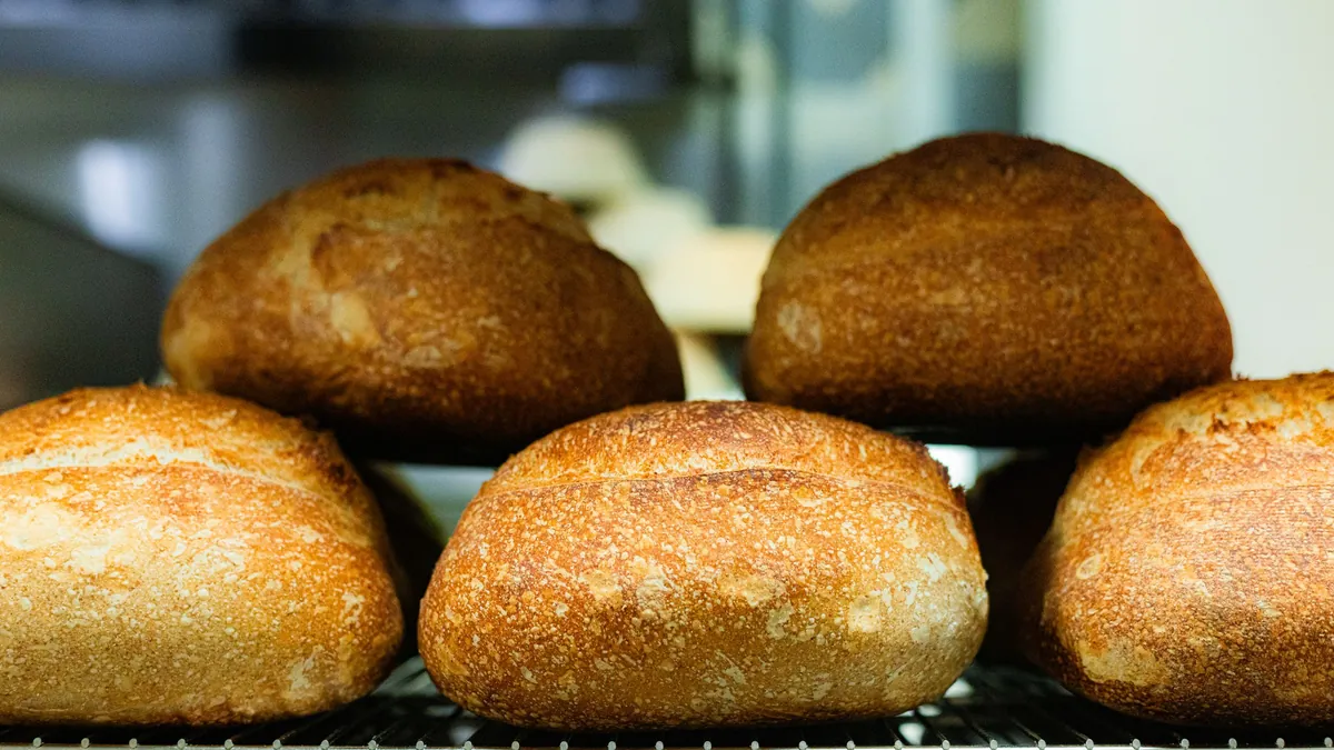 Golden loaves of bread on a cooling rack