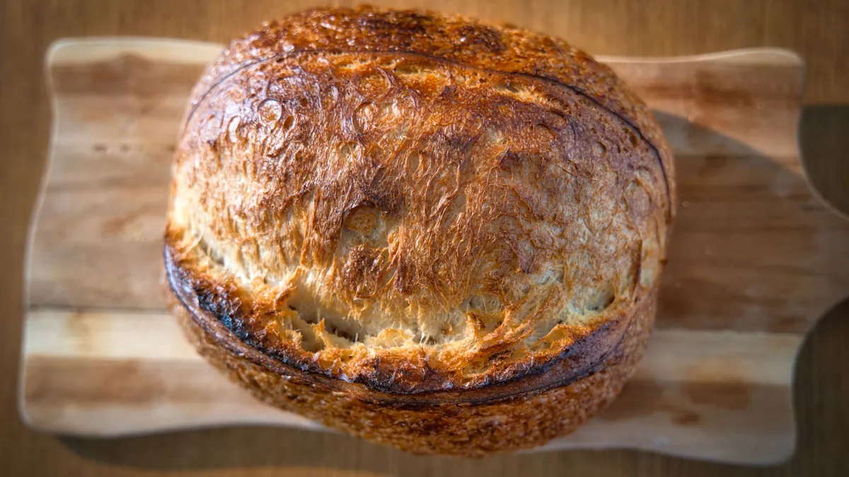 Round artisan bread loaf on a wooden board