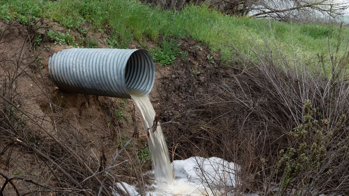 A drainage pipe discharging water into a ditch