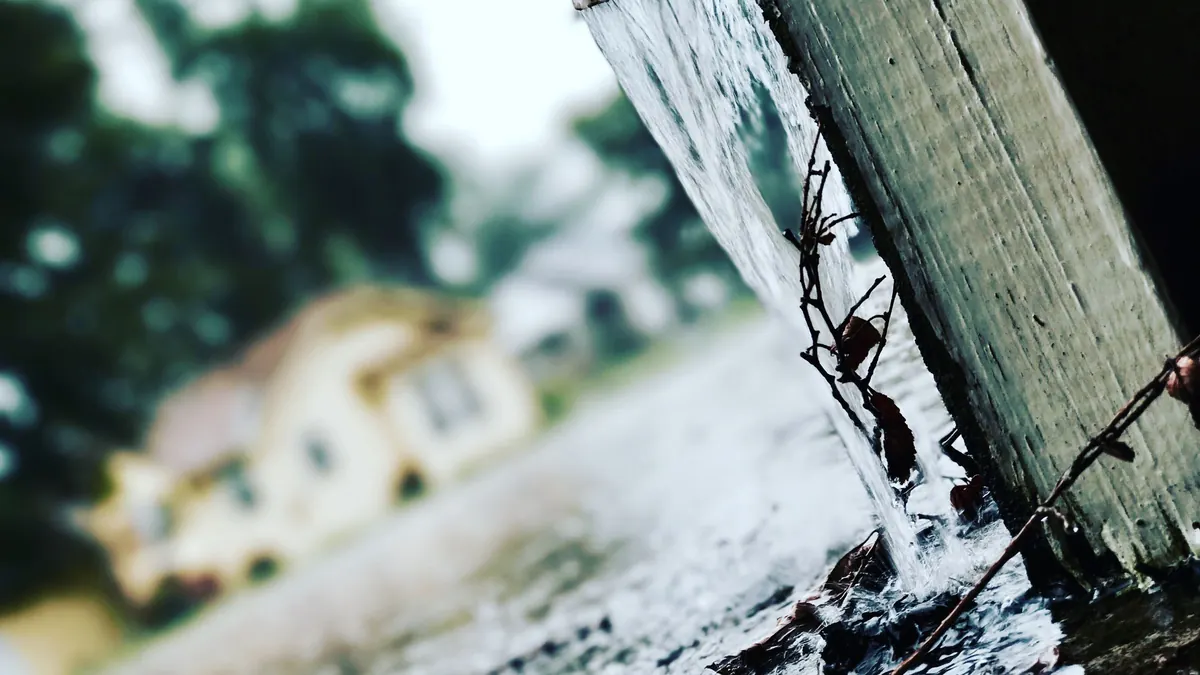 Rainwater flowing from a gutter during a storm